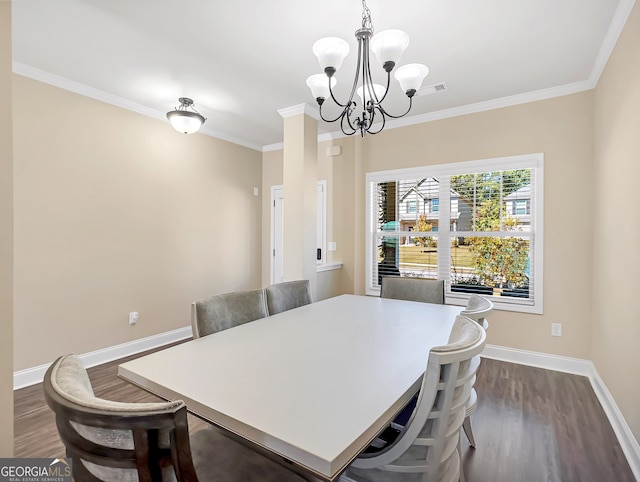 dining room featuring a notable chandelier, ornamental molding, and dark wood-type flooring