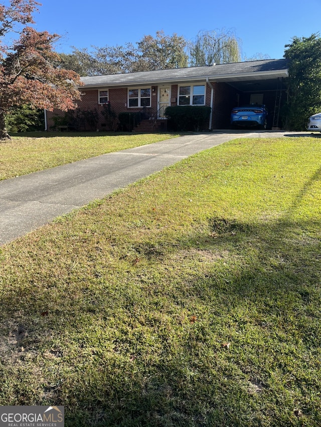 ranch-style home featuring a carport and a front yard