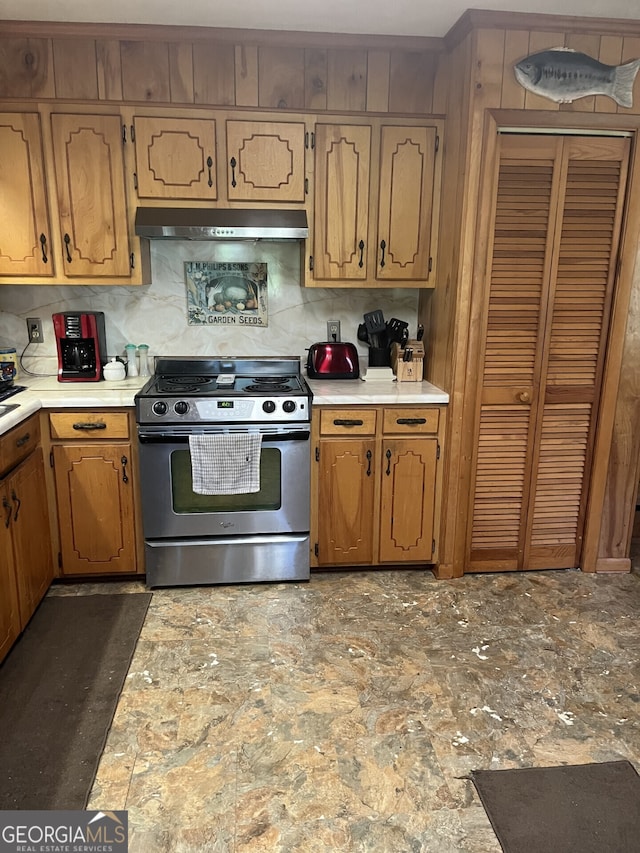 kitchen featuring stainless steel range with gas stovetop and decorative backsplash