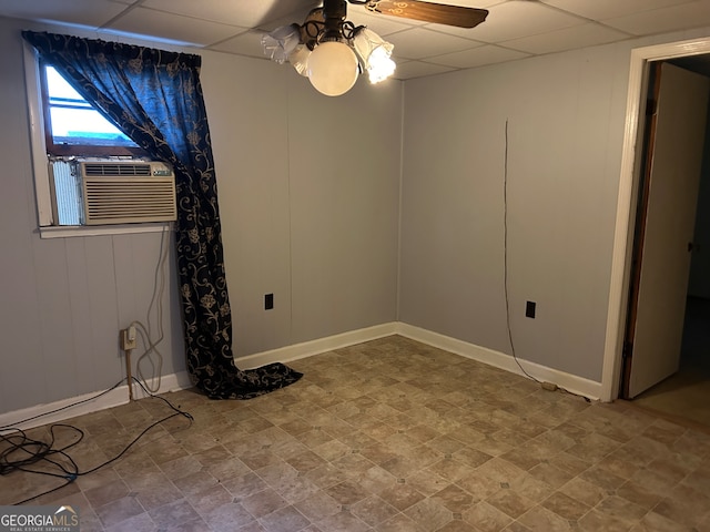 unfurnished room featuring a drop ceiling, cooling unit, and ceiling fan