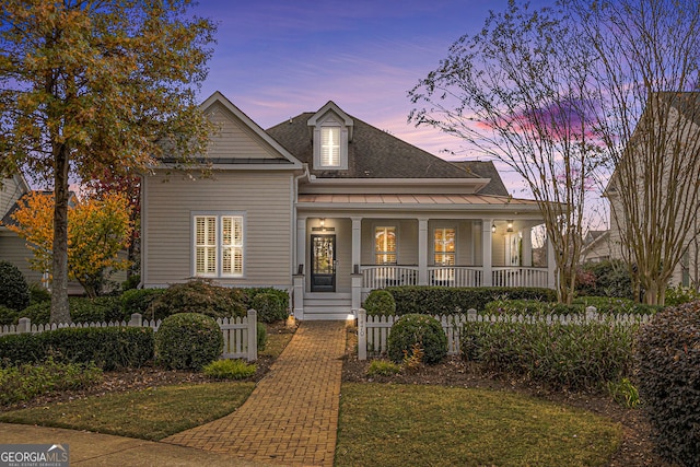 view of front of property featuring a lawn and covered porch