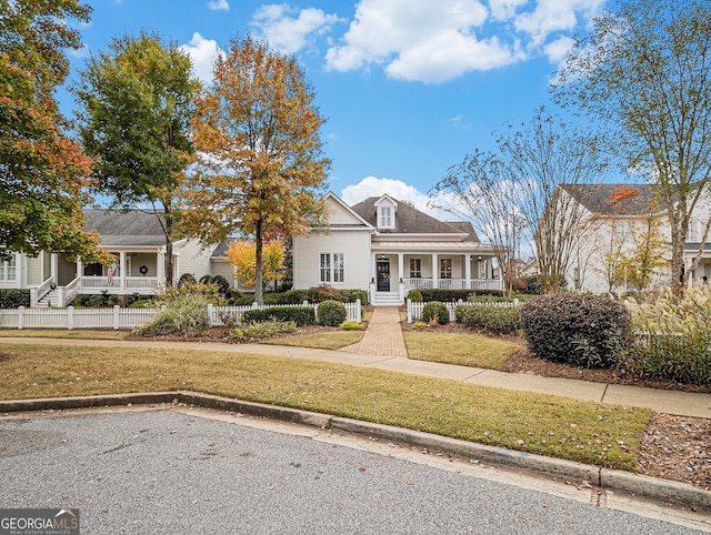 view of front facade featuring covered porch and a front yard