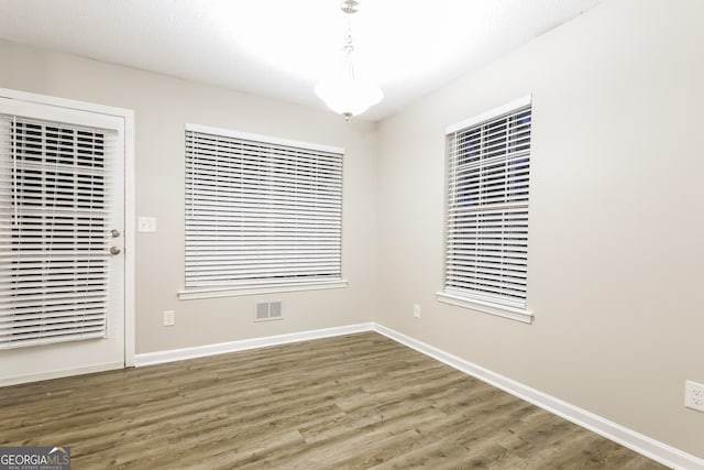 unfurnished room with wood-type flooring