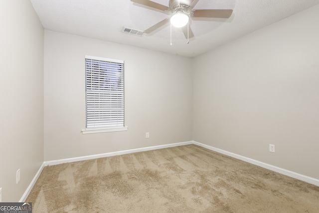 empty room with carpet flooring and ceiling fan