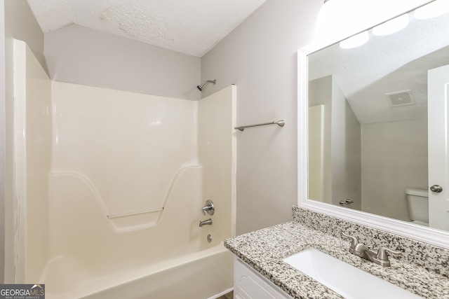 full bathroom featuring vanity, toilet, bathtub / shower combination, and a textured ceiling