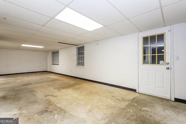 basement featuring a paneled ceiling