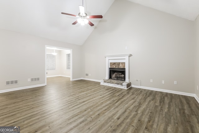 unfurnished living room with dark hardwood / wood-style floors, high vaulted ceiling, and ceiling fan