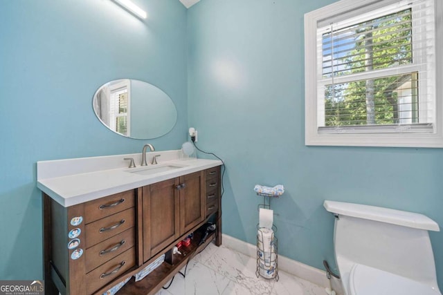 bathroom featuring toilet and vanity