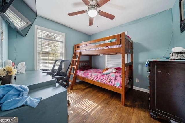 bedroom with ceiling fan and wood-type flooring