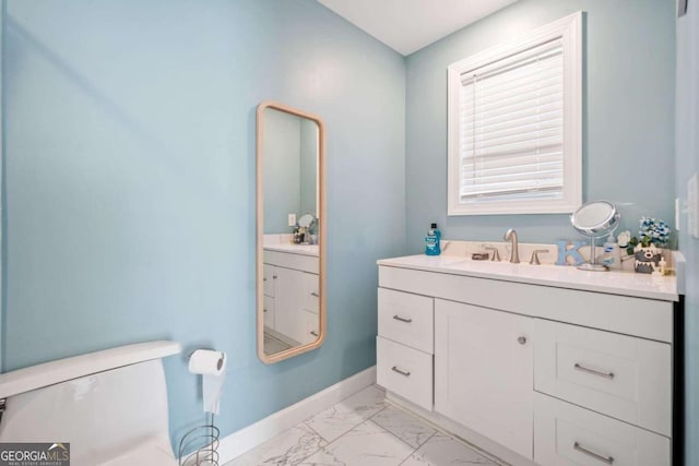 bathroom featuring vanity and toilet