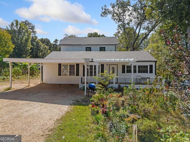 rear view of property with a carport