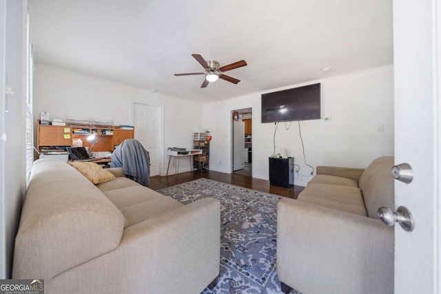 living room with dark wood-type flooring and ceiling fan