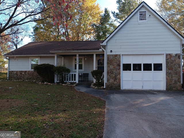 single story home featuring covered porch, a garage, and a front yard