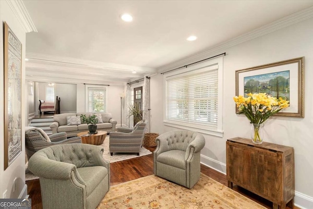 sitting room featuring baseboards, wood finished floors, recessed lighting, and crown molding
