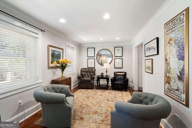 sitting room featuring baseboards, crown molding, wood finished floors, and recessed lighting