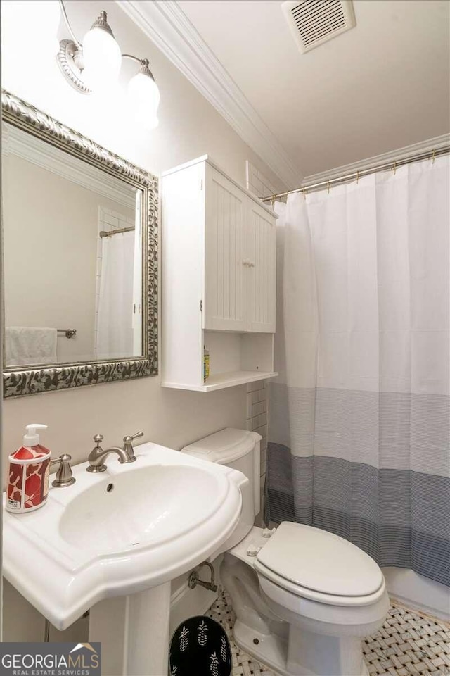 bathroom featuring tile patterned floors, crown molding, curtained shower, and toilet