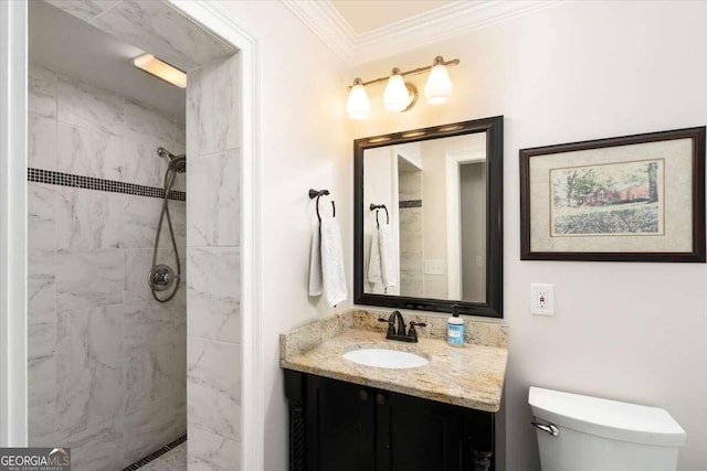 full bath featuring a tile shower, toilet, ornamental molding, and vanity