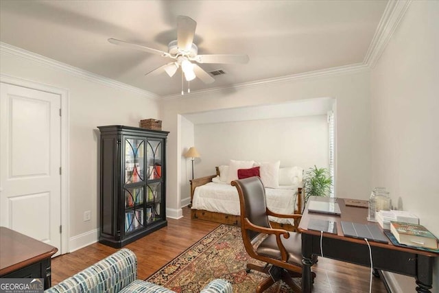 bedroom with a ceiling fan, wood finished floors, baseboards, ornamental molding, and visible vents