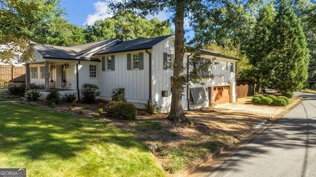 view of side of property with a garage and a lawn