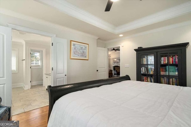 bedroom featuring ceiling fan, crown molding, and stone tile floors