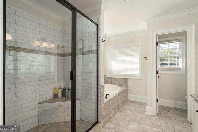 bathroom with a shower stall, a garden tub, crown molding, and baseboards