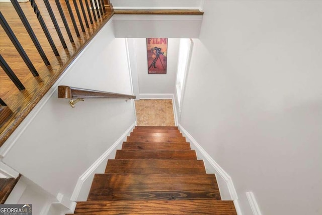 stairs with hardwood / wood-style flooring