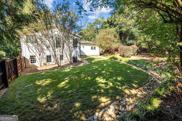 view of yard featuring a fenced backyard and an outbuilding