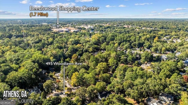 birds eye view of property with a view of trees