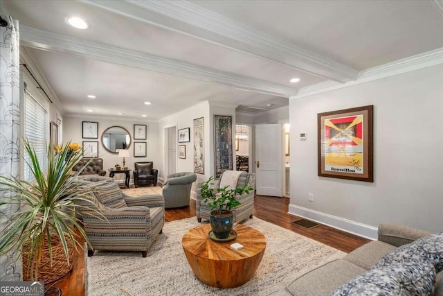 living room featuring crown molding, hardwood / wood-style flooring, and beamed ceiling