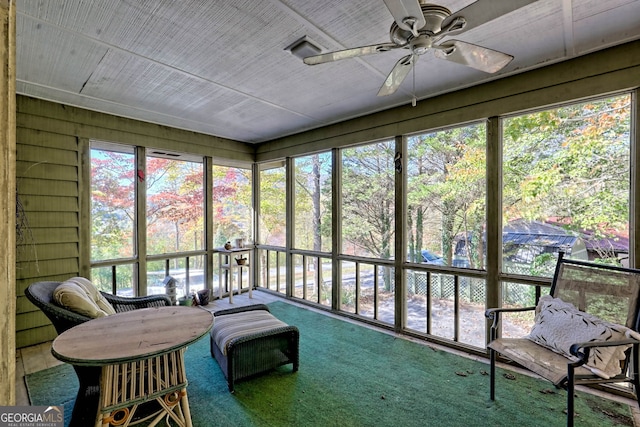 sunroom / solarium featuring ceiling fan