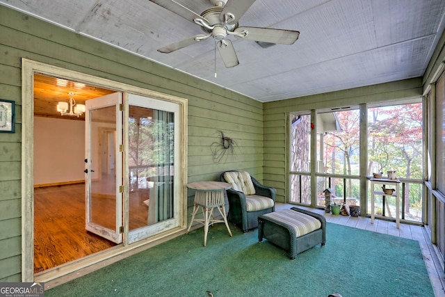 sunroom featuring ceiling fan