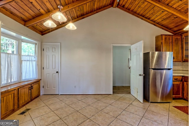 kitchen featuring vaulted ceiling with beams, wood ceiling, hanging light fixtures, stainless steel fridge, and light tile patterned floors