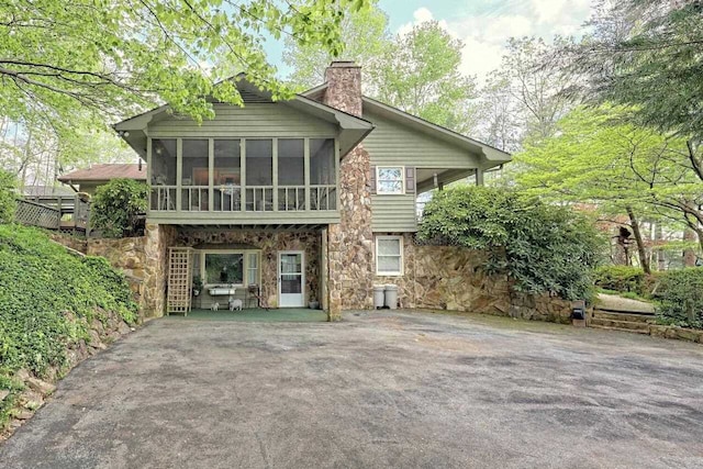 rear view of house with a sunroom and a patio area