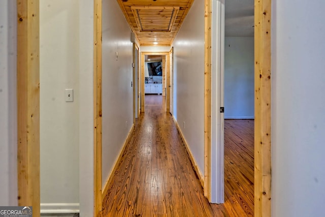 hallway featuring hardwood / wood-style flooring and wooden ceiling