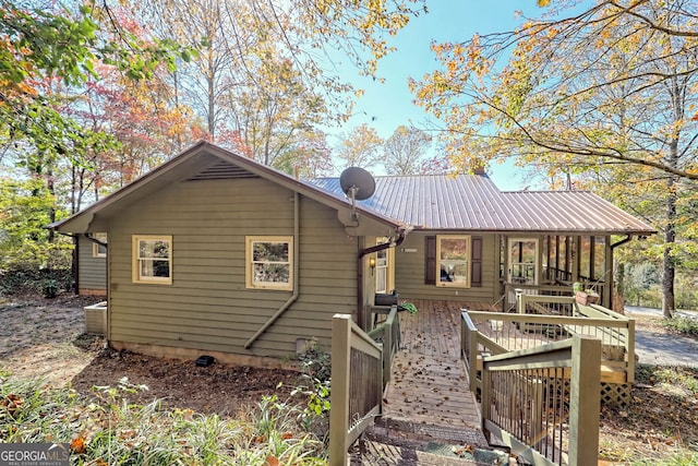 back of property featuring a wooden deck