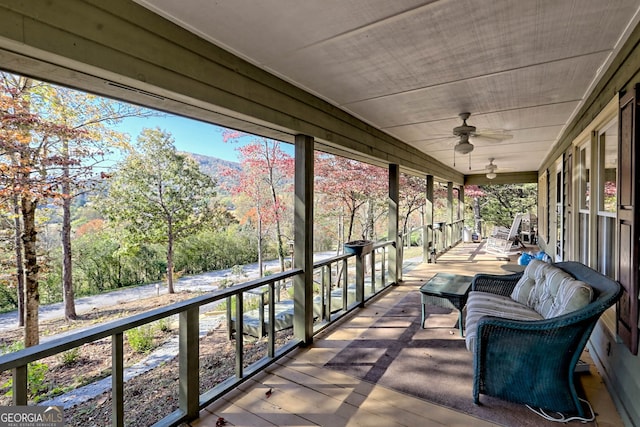 wooden deck with covered porch and ceiling fan