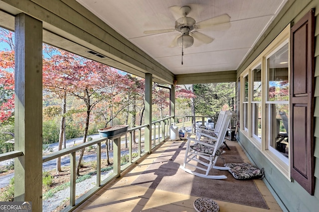 exterior space featuring ceiling fan and plenty of natural light