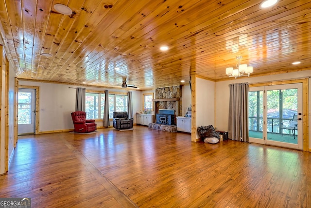 unfurnished living room with a wealth of natural light, wood ceiling, and hardwood / wood-style flooring