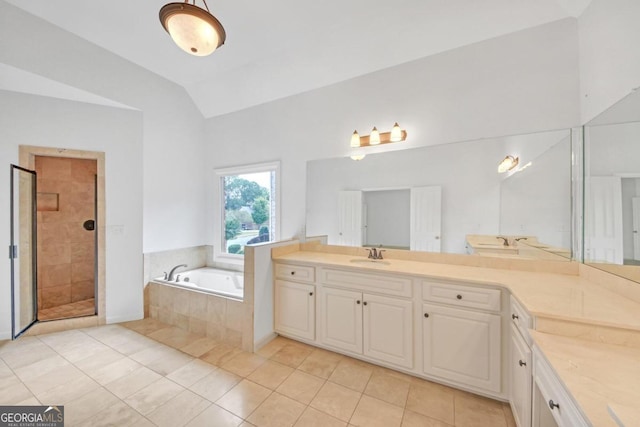 bathroom featuring tile patterned flooring, vanity, independent shower and bath, and vaulted ceiling