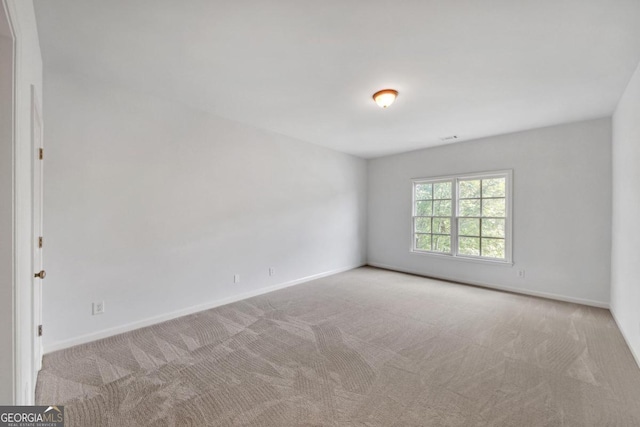 empty room featuring light carpet