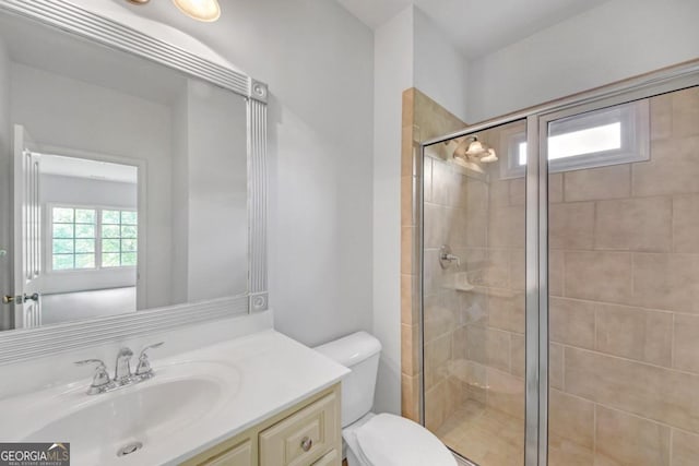 bathroom with vanity, toilet, and walk in shower