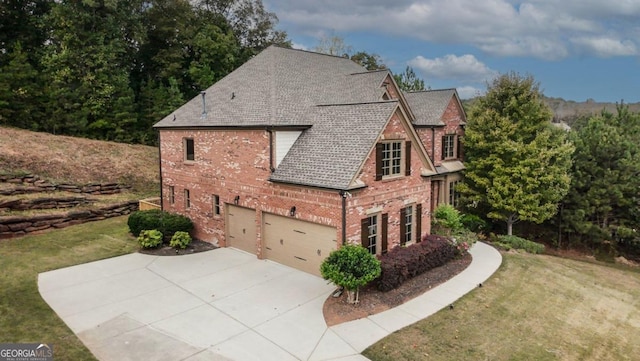 view of side of property with a lawn and a garage