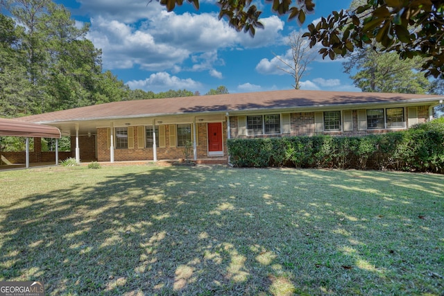 ranch-style home featuring a front lawn and a carport