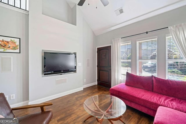 living room with ceiling fan, dark wood-type flooring, and high vaulted ceiling