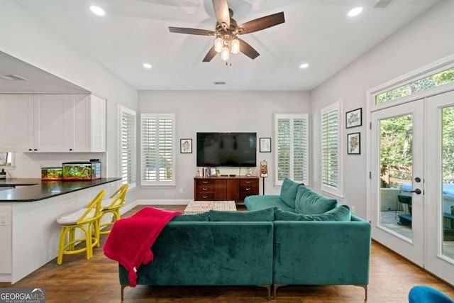 living room with ceiling fan, french doors, and light hardwood / wood-style flooring