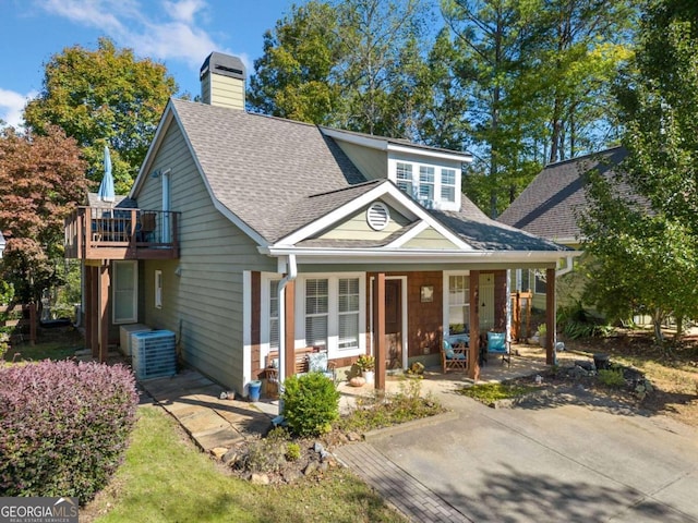 view of front of house with a porch and central air condition unit