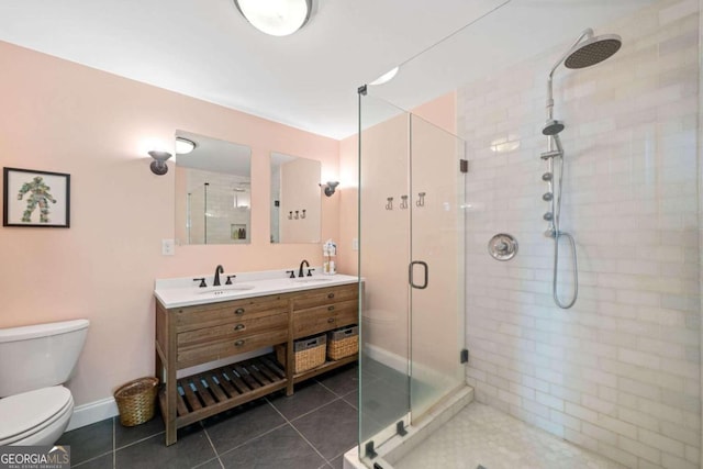 bathroom with toilet, tile patterned floors, walk in shower, and vanity