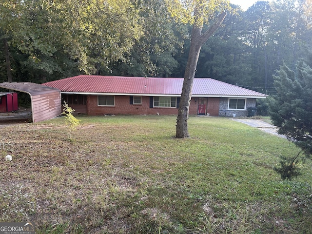 ranch-style home with brick siding, metal roof, and a front lawn