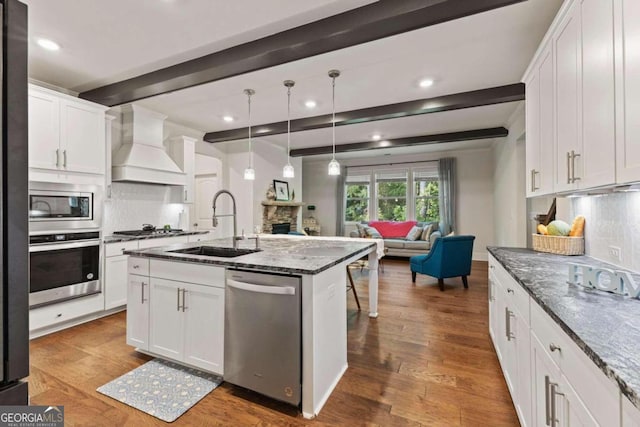 kitchen featuring beamed ceiling, custom exhaust hood, dark wood-type flooring, and stainless steel appliances