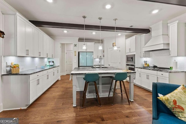 kitchen with dark hardwood / wood-style floors, hanging light fixtures, custom range hood, stainless steel appliances, and white cabinets